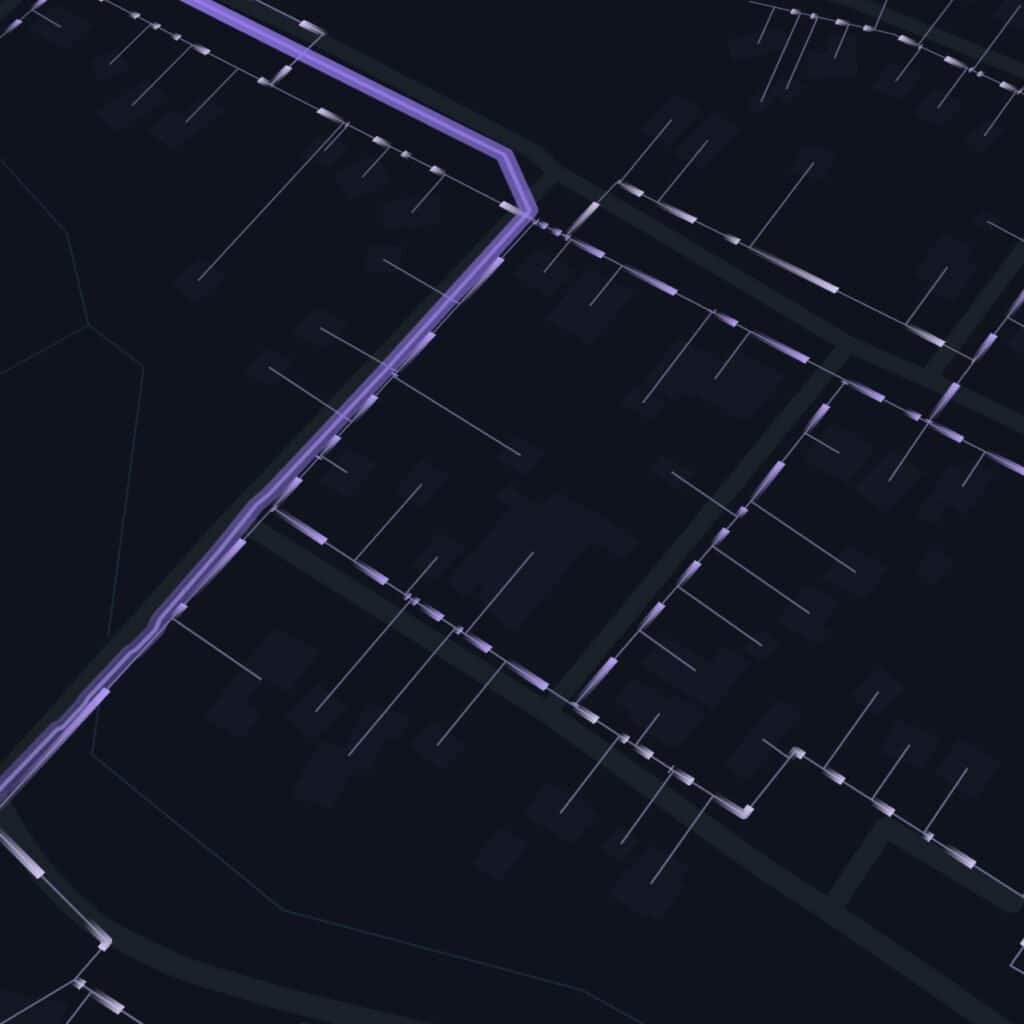 A digital map display shows intersecting streets and property boundaries highlighted with thin purple and white lines on a dark background.